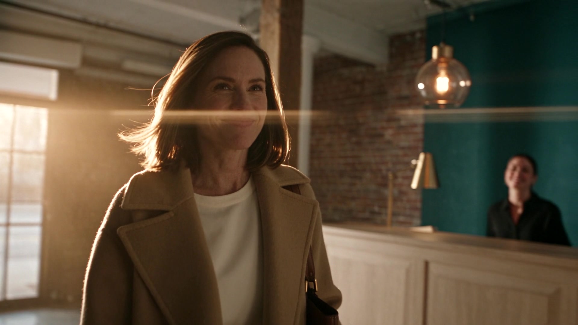 A patient arriving at a softly lit reception desk