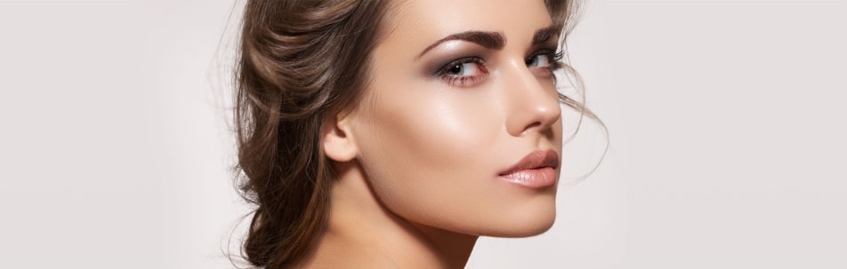 Stock photograph of a model in profile looking toward the camera