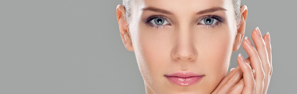 Stock photograph of a model's face with her hand at her cheek