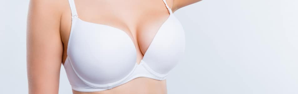 Stock photograph of a model in a white bra, shown from the shoulders down