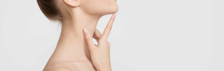 Stock photograph of a model's neck and jaw with a hand at her chin