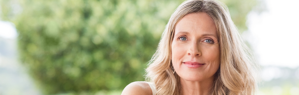 Stock photograph of a mature model with blonde hair smiling at the camera
