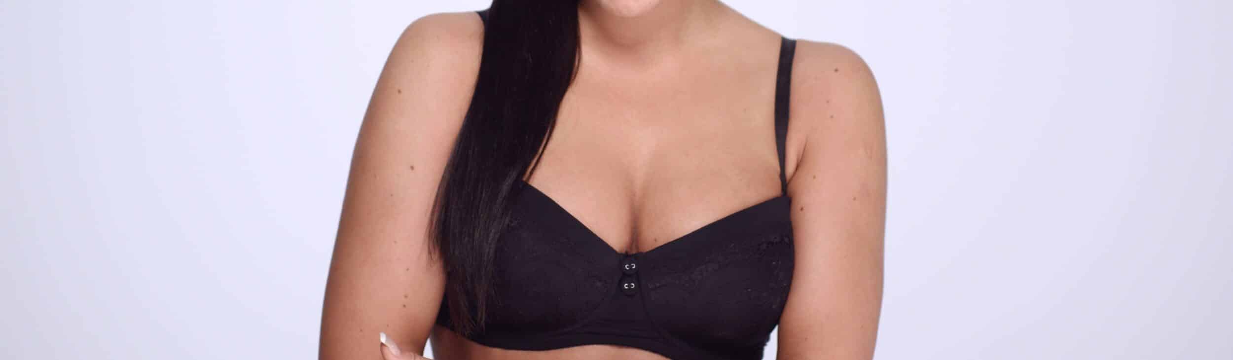 Stock photograph of a model in a black bra, shown from the neck to the waist